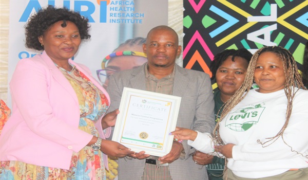 Inkosi TM Gumede handing a certificate to Malaria Control Programme Management