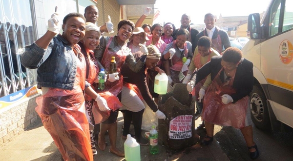 uMgungundlovu Health District staff members removing illegal abortion posters in the Pietermaritzburg city area during Mandela Day 2016